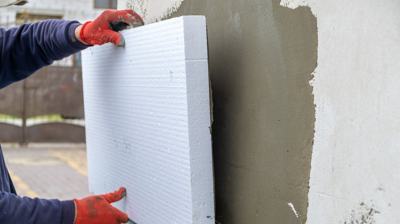 installing Styrofoam insulation sheets
