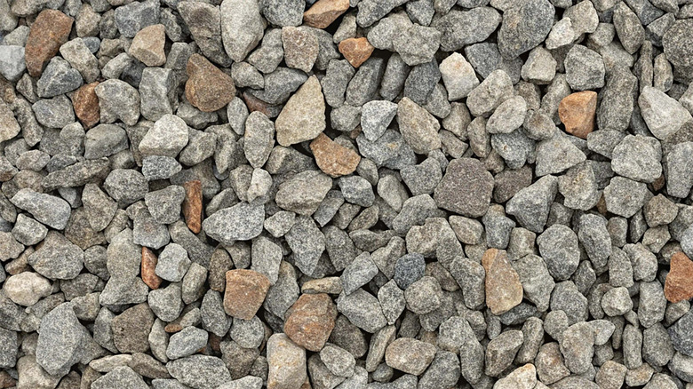 image of angular crushed gravel with jagged, interlocking stones in shades of gray and brown.