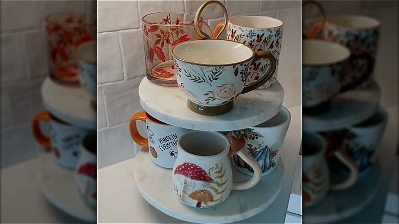 A selection of mugs displayed on a marble cake stand