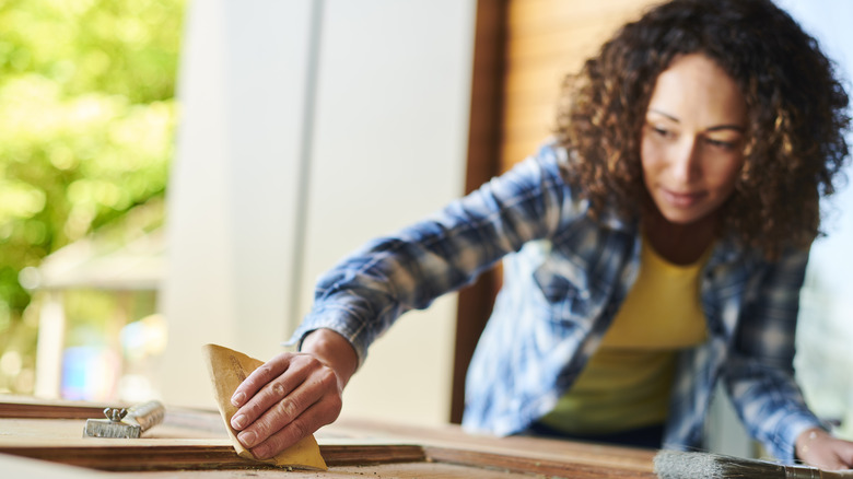 Woman sanding wood