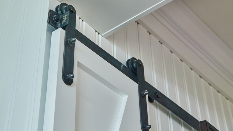 Barn door track with metal hardware