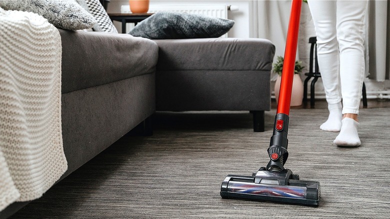 Person vacuuming carpet