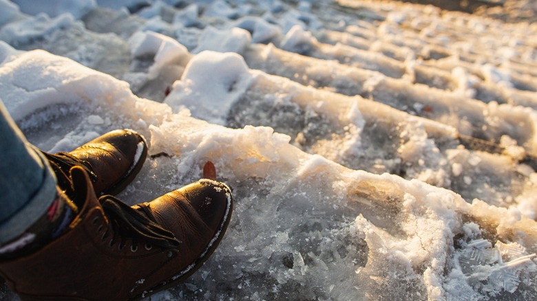 A person standing at the top of very icy steps