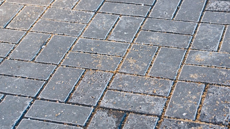 Brick surface with salt and sand spread as deicer