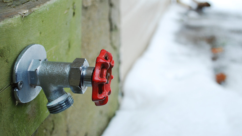 Exterior hose faucet on snowy day