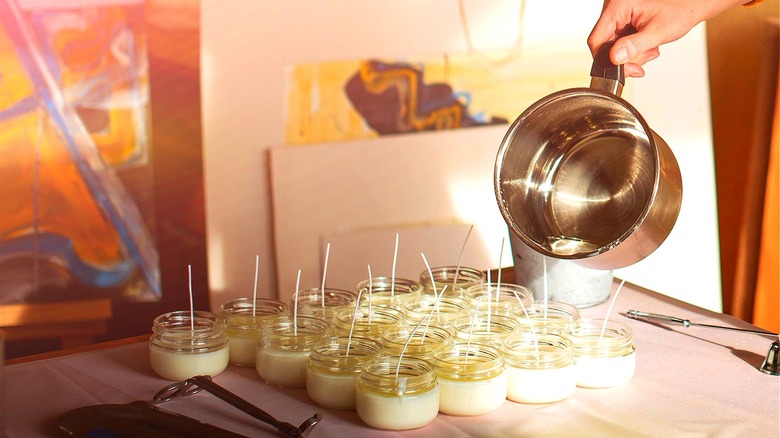 Person pouring wax for candles