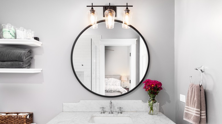 Bathroom with mirror and light fixture