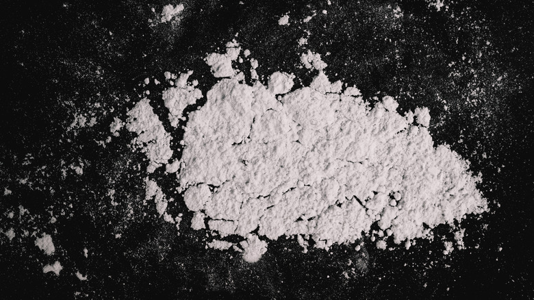 white alum powder on black table