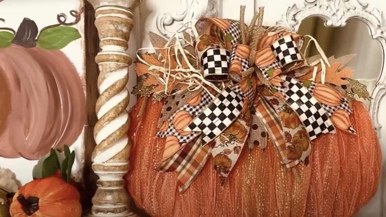 A completed Dollar Tree ribbon pumpkin wall decor piece