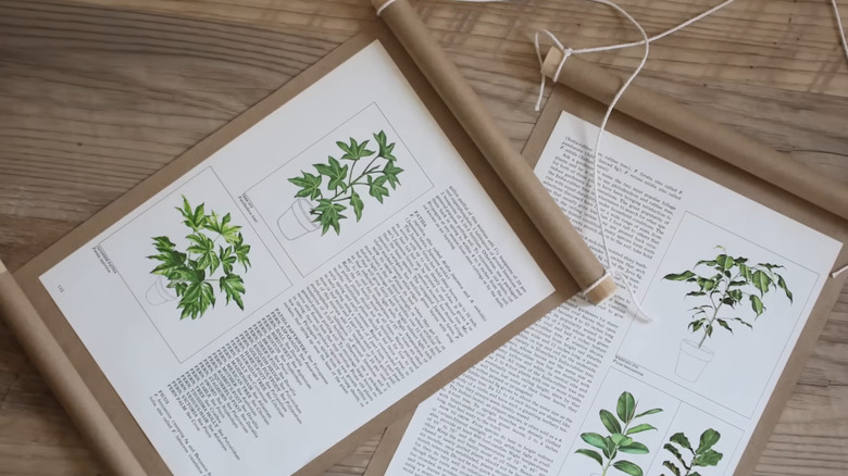 Handcrafted book page banners lay spread out on a wooden tabletop.
