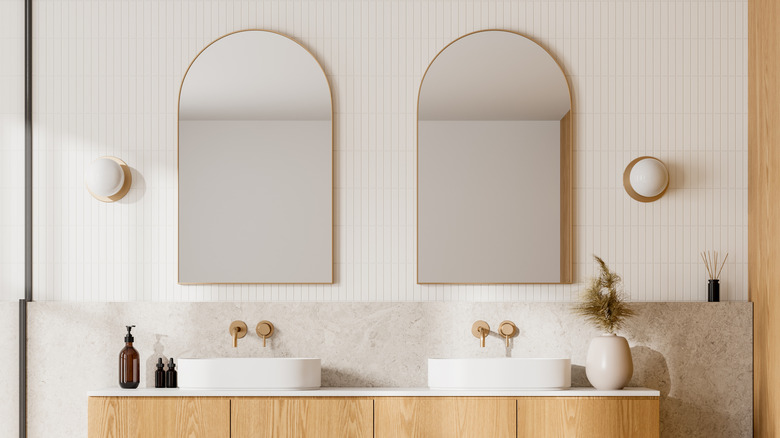 Arched bathroom mirrors in chic white minimalist bathroom