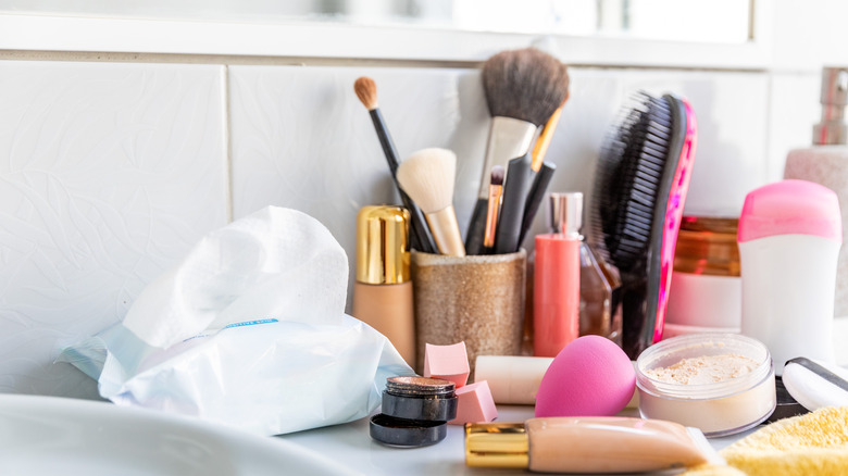 A messy bathroom counter that is very cluttered