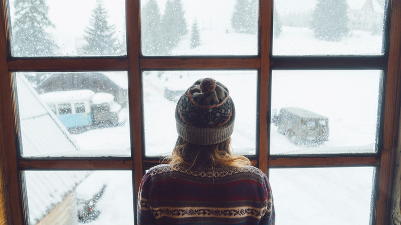 Woman looking in the window in winter