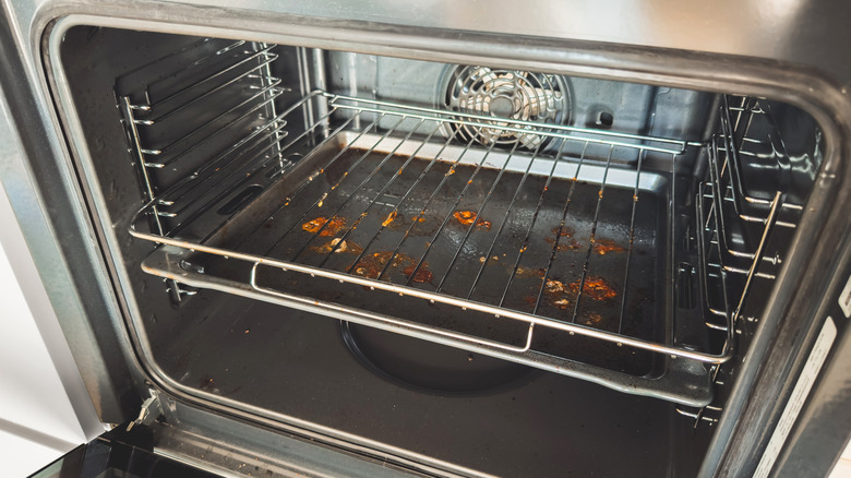 dirty oven rack covered in orange food spills