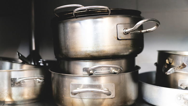 Pots and pans stacked on a shelf