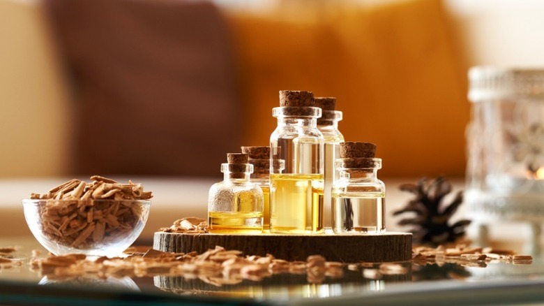 Collection of cedarwood essential oil vials surrounding by cedar chips