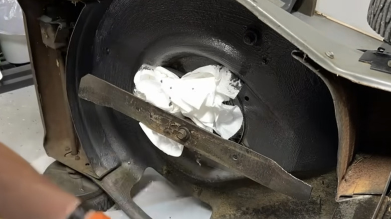 Painting the metal deck of a lawn mower to stop grass sticking to it