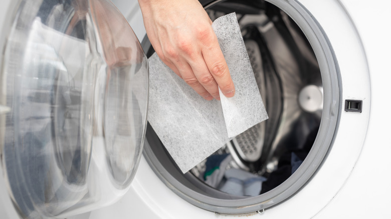 Inserting dryer sheet in dryer