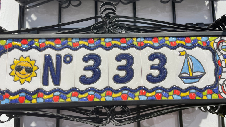 fun house number with multi-color detailing of a sun and sailboat