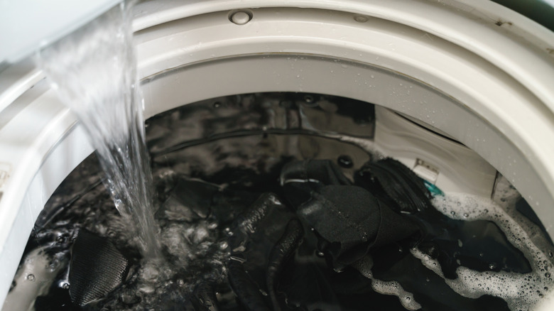 water pouring into a washing machine