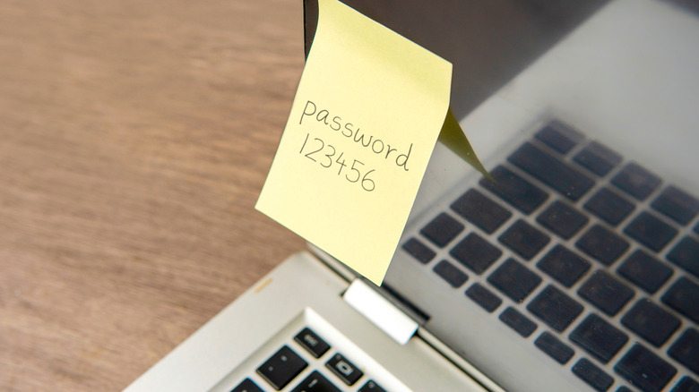 Password on sticky note attached to laptop