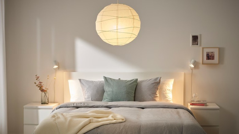IKEA REGOLIT pendant lamp hanging in a bedroom