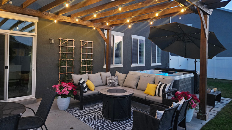 outdoor fire pit with sectional and hot tub