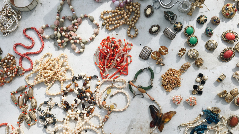 Table full of thrifted jewelry