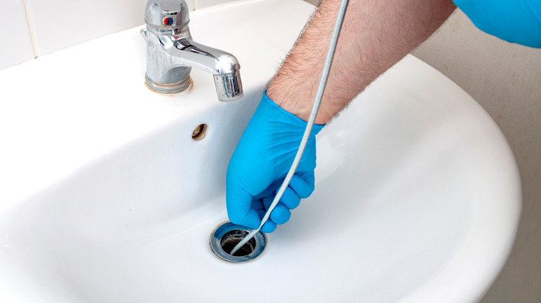 https://www.housedigest.com/img/gallery/the-easy-zip-tie-hack-that-will-help-clean-your-shower-drain/make-a-diy-plumbing-snake-1668805779.jpg