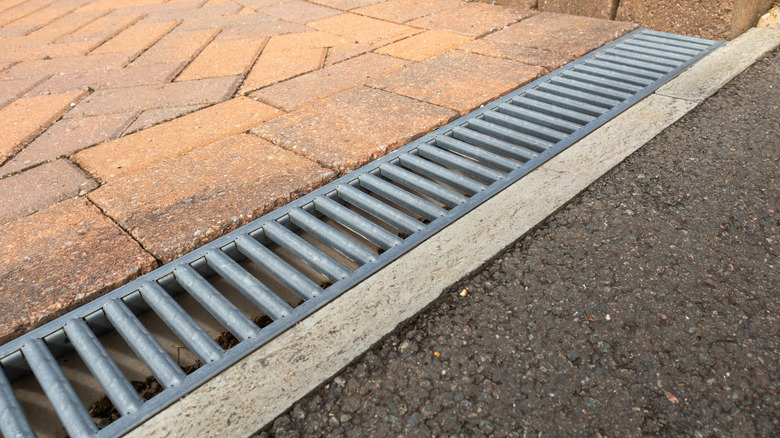 Channel drain with metal grate in a driveway