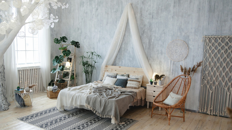 Fabric draped over a headboard in boho-themed bedroom