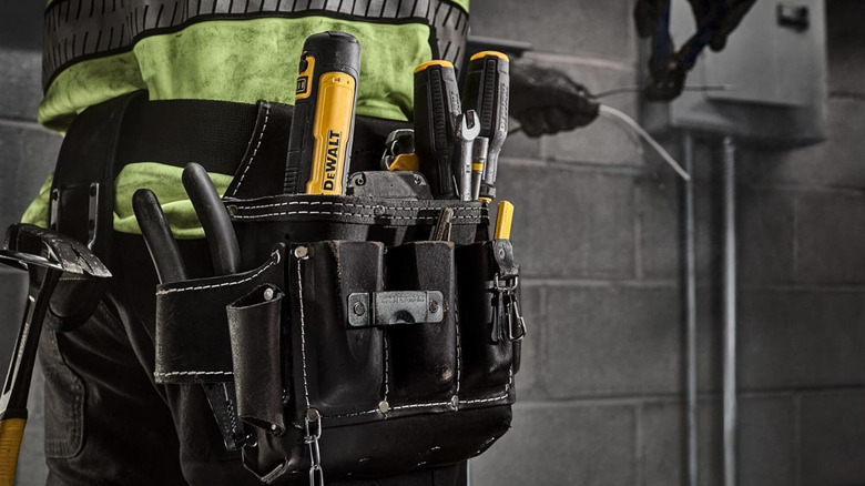 Worker with tool belt full of DeWalt tools