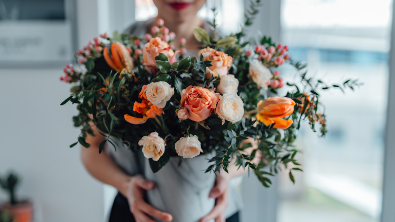 Woman holding a bouquet of flowers