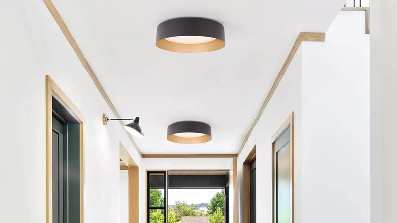 two flush-mount lighting fixtures in modern hallway