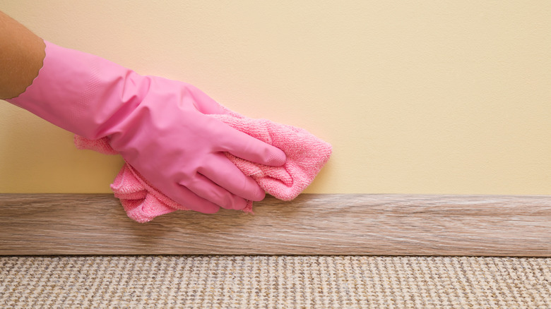 woman cleaning canary yellow wall