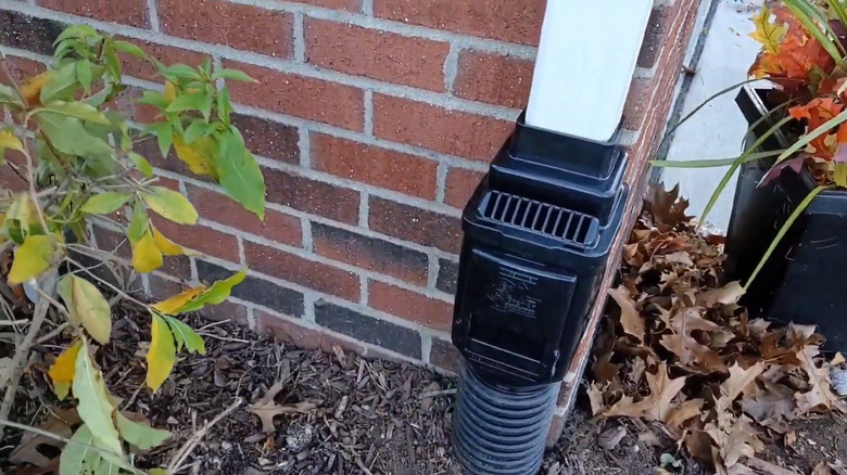 A downspout vent connecting the visible downspout to the buried one