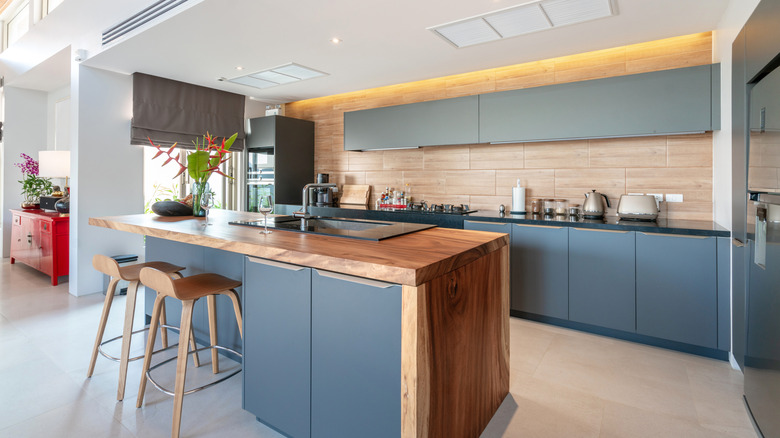 real estate Luxury interior design pool villa in kitchen area which feature island counter and built in furniture
