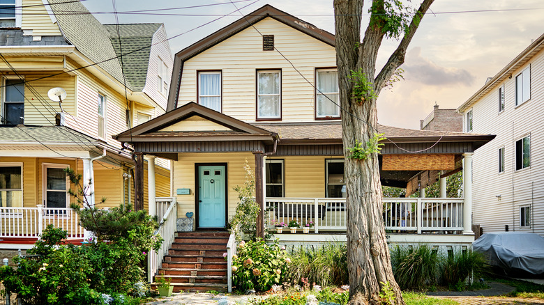 A slightly run-down yellow house exterior
