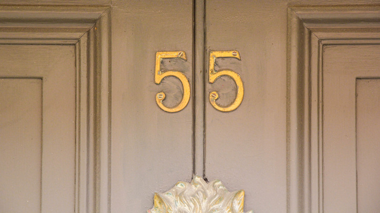 House door with aged, outdated numbers