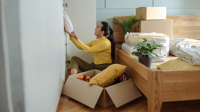 A person decluttering and organizing their closet