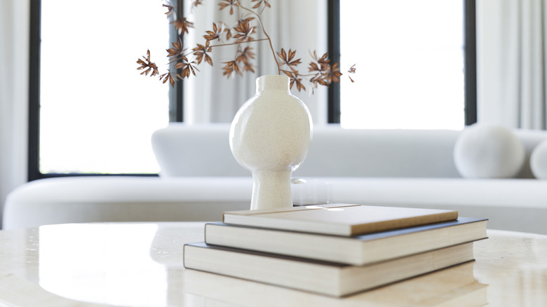 White vase filled with fall foliage on coffee table