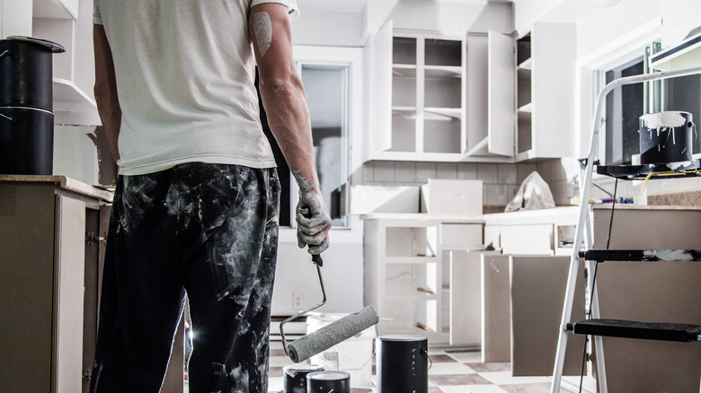 Person painting kitchen white