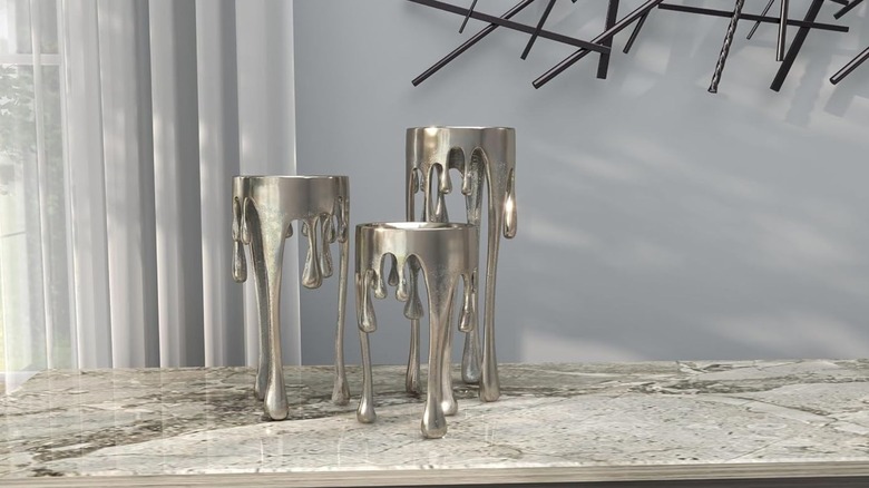 The CosmoLiving Metal Abstract Decorative Drip Candle Stand trio