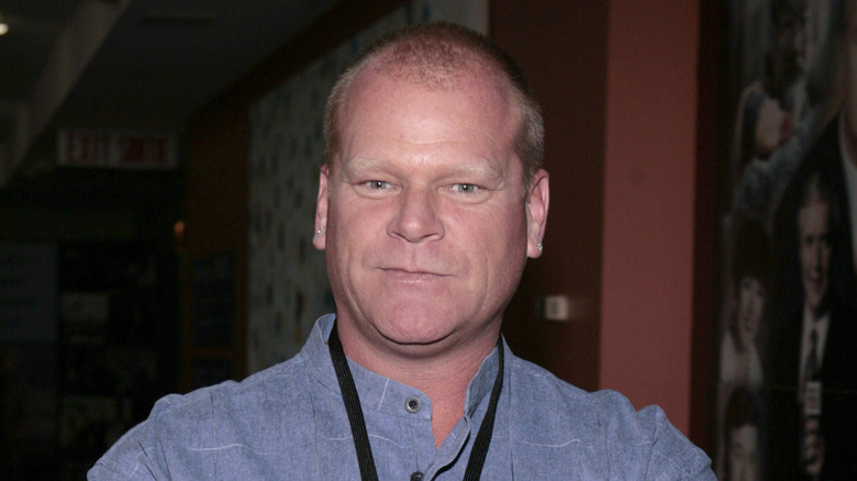 Mike Holmes posing in blue shirt