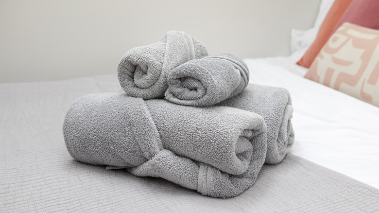 A stack of rolled-and-tucked towels