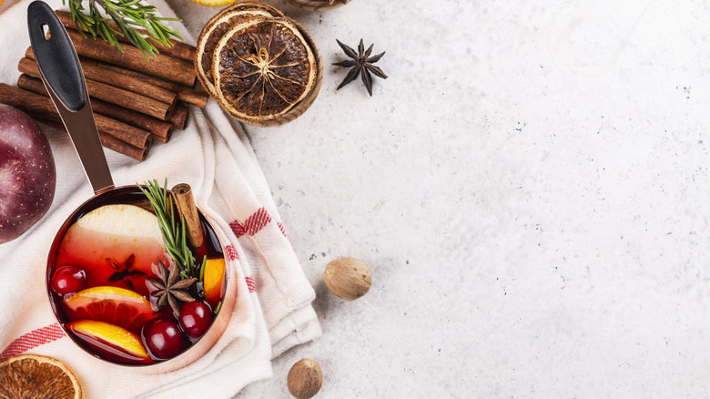 Close up of Christmas simmer pot ingredients, including spices, oranges, and cranberries