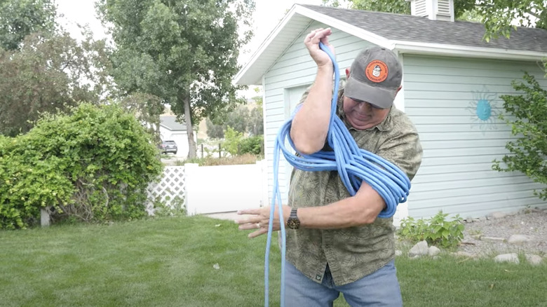 person wrapping cord