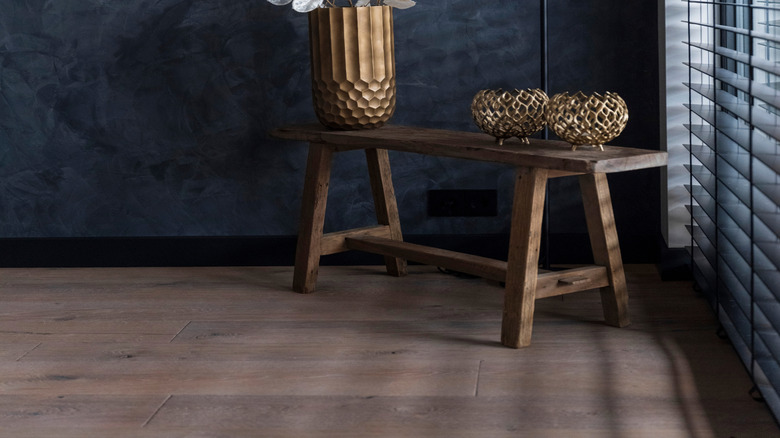 Home interior featuring stylish decor and a dark, navy limewash wall paint finish