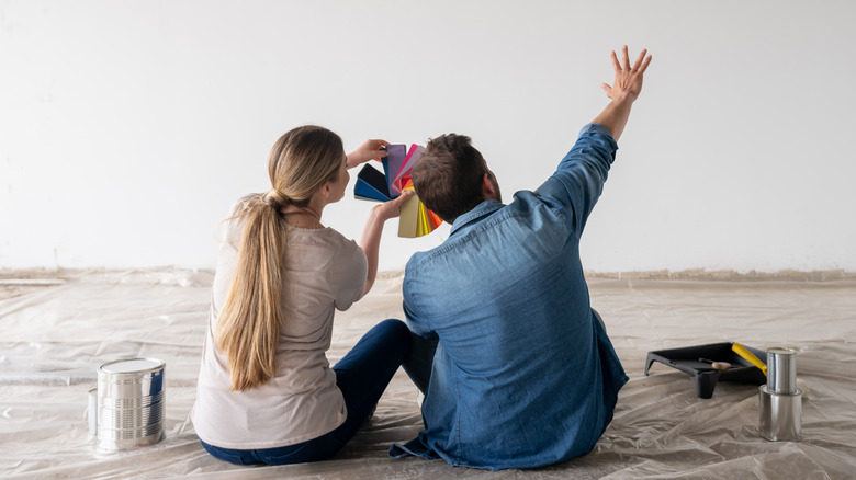Couple holding up paint swatches