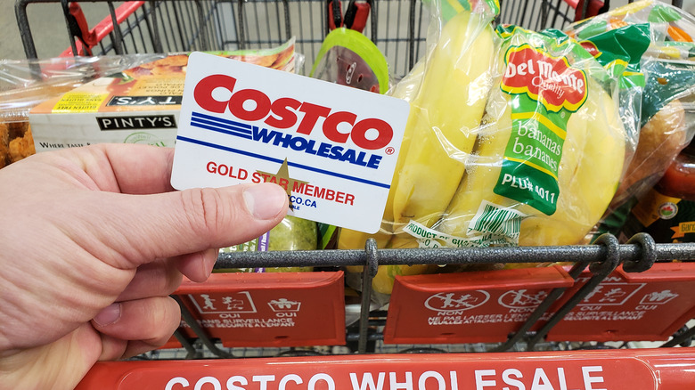Costco card and hand